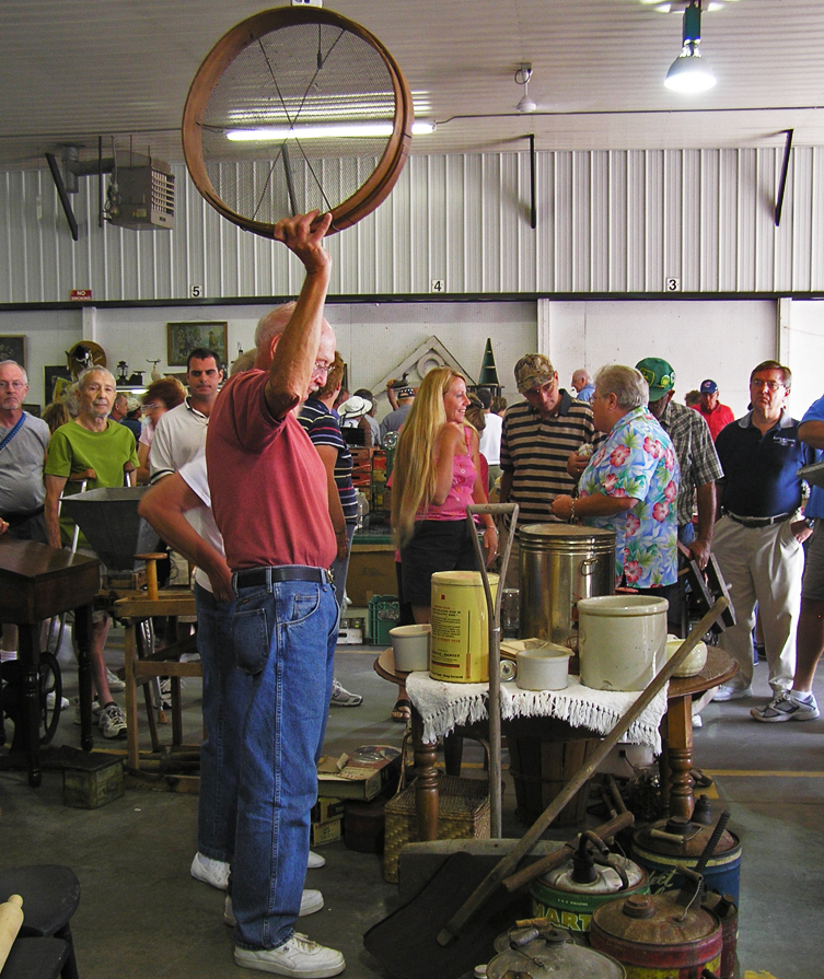 Man holding an item being auctioned