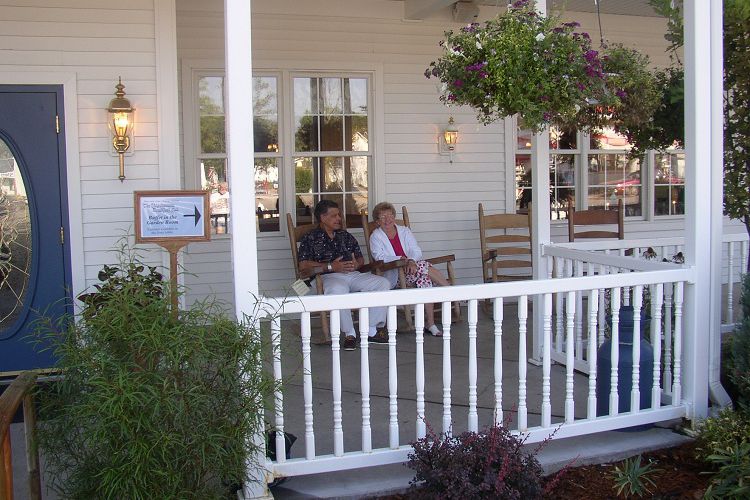 Two people sitting on porch at Blue Gate Restaurant and Bakery