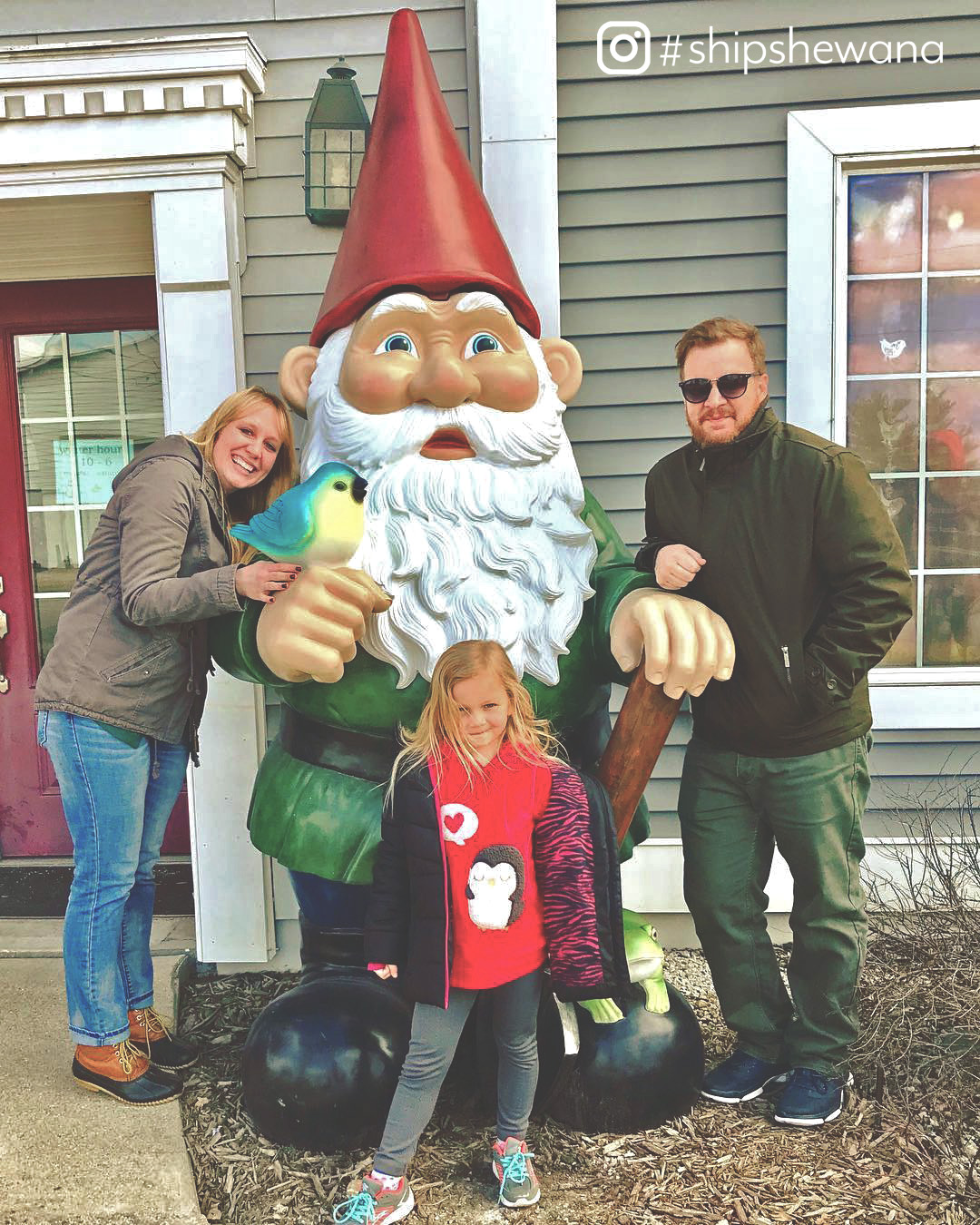 People posing with giant gnome