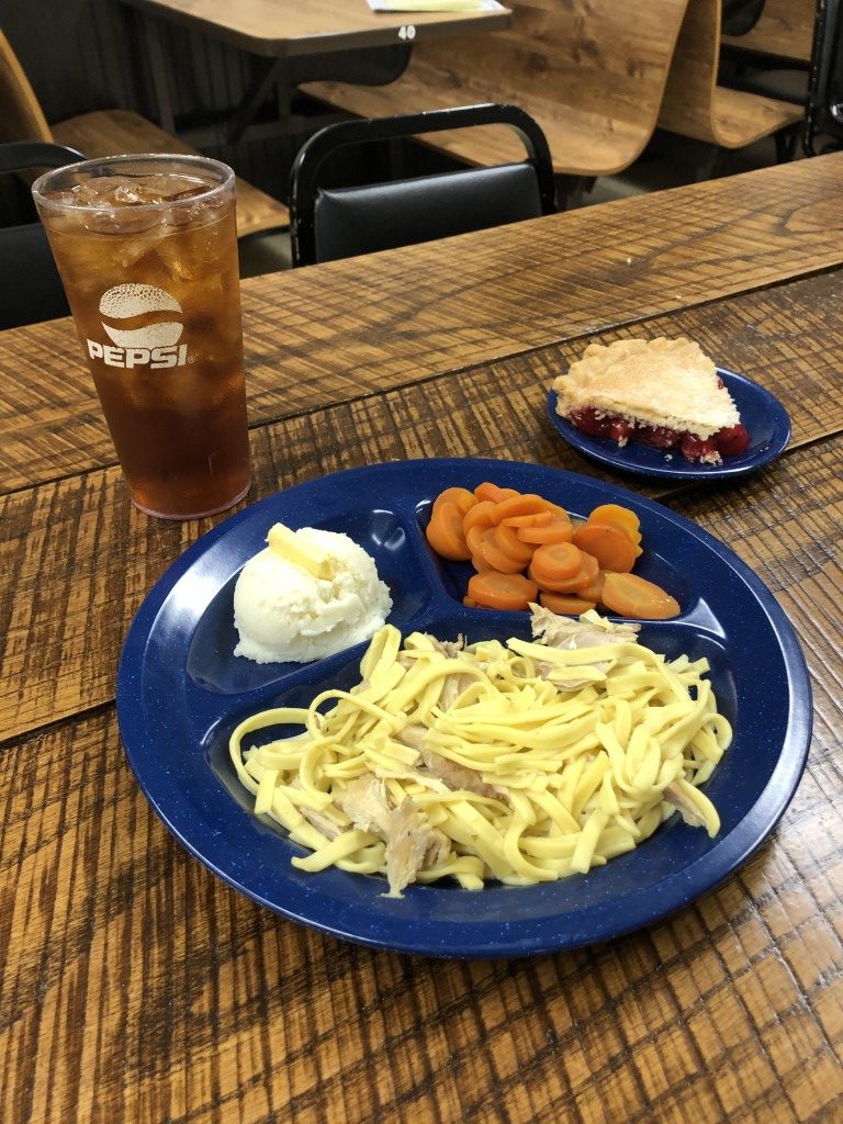 Chicken and noodles with mashed potatoes, carrots, cherry pie and a fountain drink