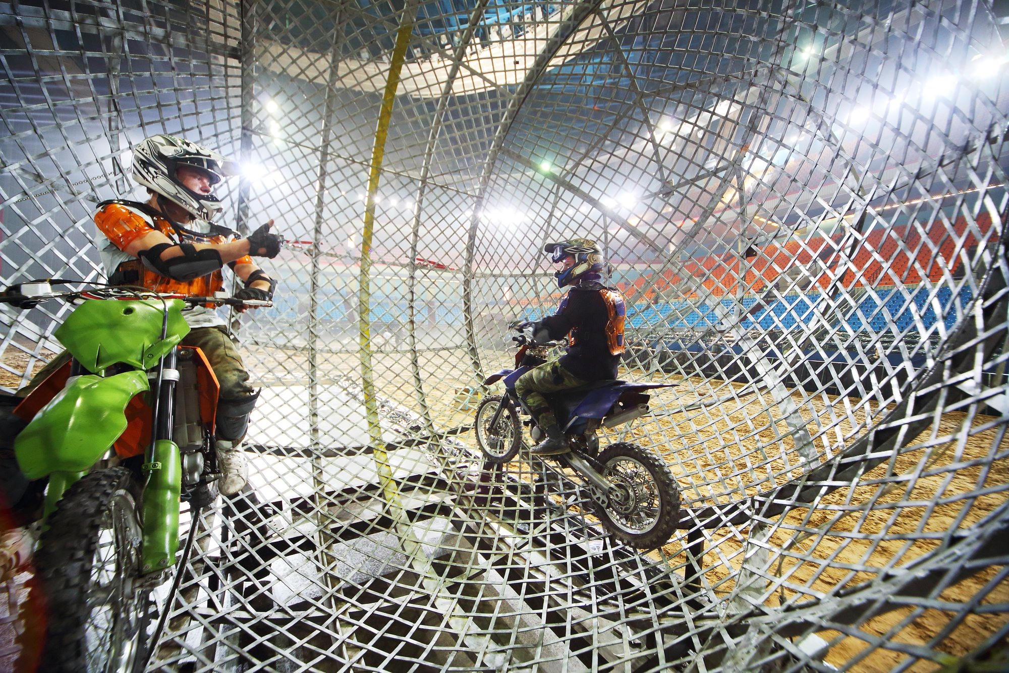 two dirt bike riders inside chain sphere
