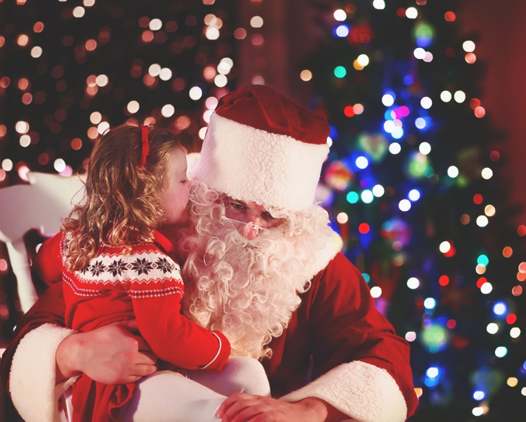 little girl whispering in santa's ear