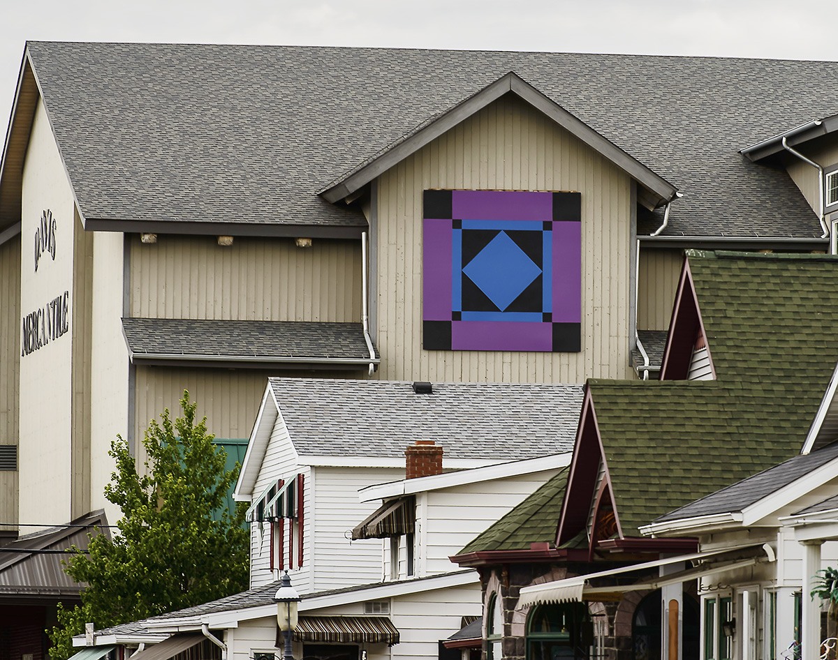 Purple, blue, and black barn quilt