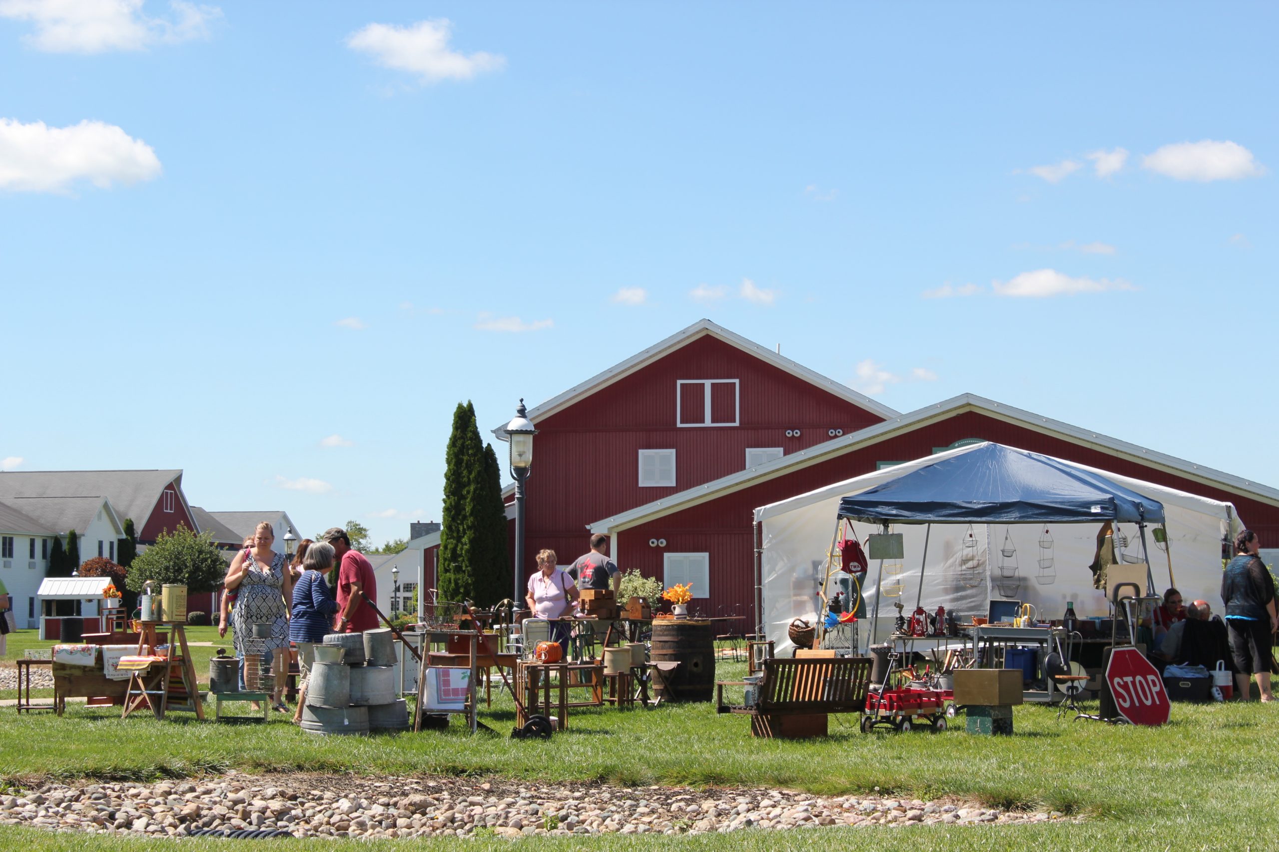 Antique and vintage market tents, barn, and sale items.