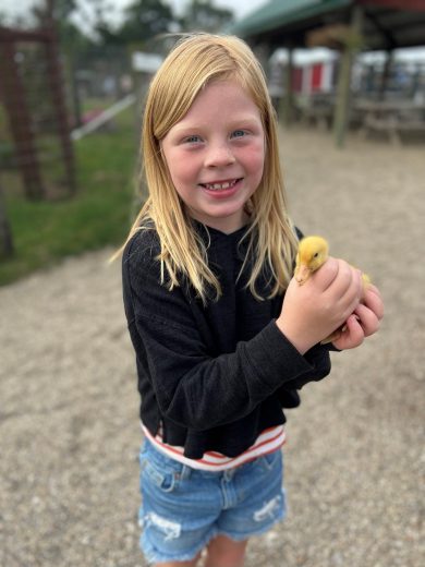 Little girl holding duck