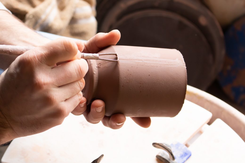 Artist creating pottery, Riverwood Pottery.