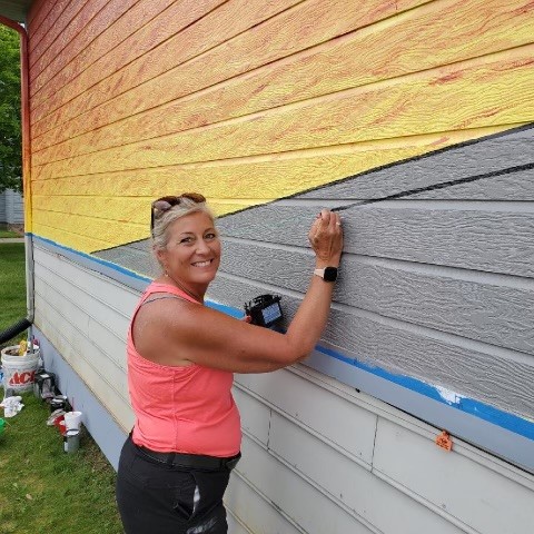 Amy painting a mural