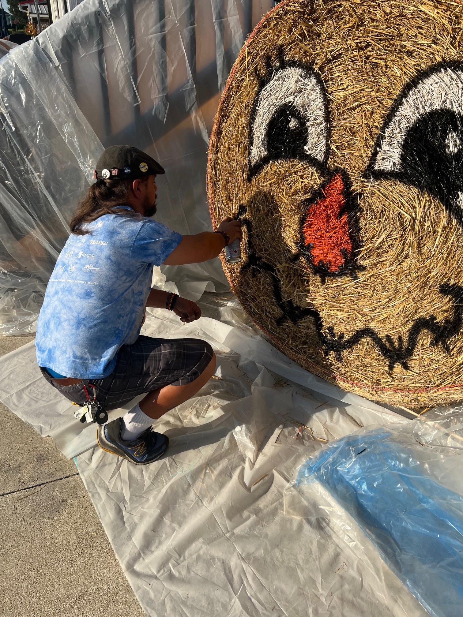 Josh Cooper painting Harrison the Scarecrow